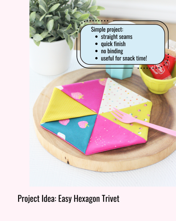 Colourful hexagon trivet made from bright patterned fabric triangles, displayed on a wooden board with snacks. Beginner sewing project using straight seams and no binding.