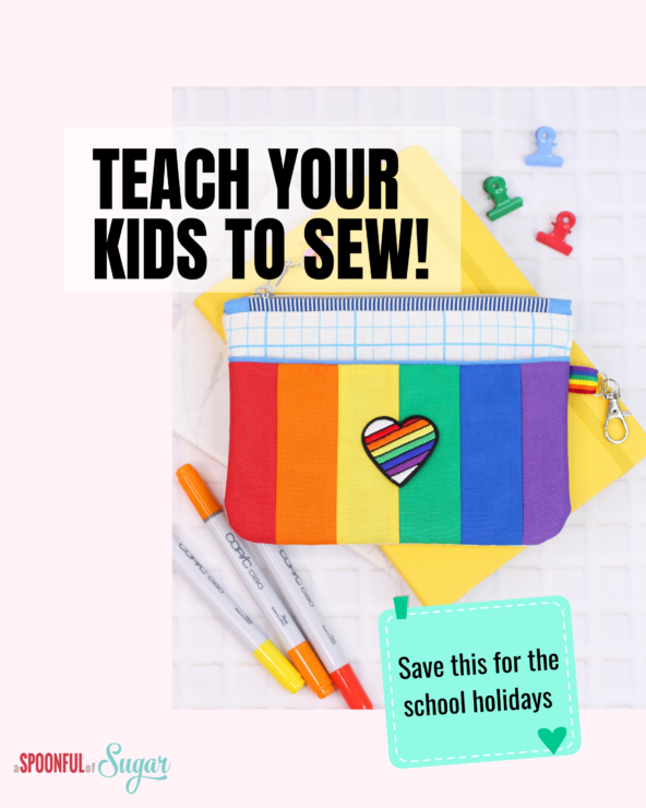 Rainbow‑striped zippered pouch with heart appliqué placed on a notebook with colourful markers and clips, promoting sewing activities for kids during school holidays.
