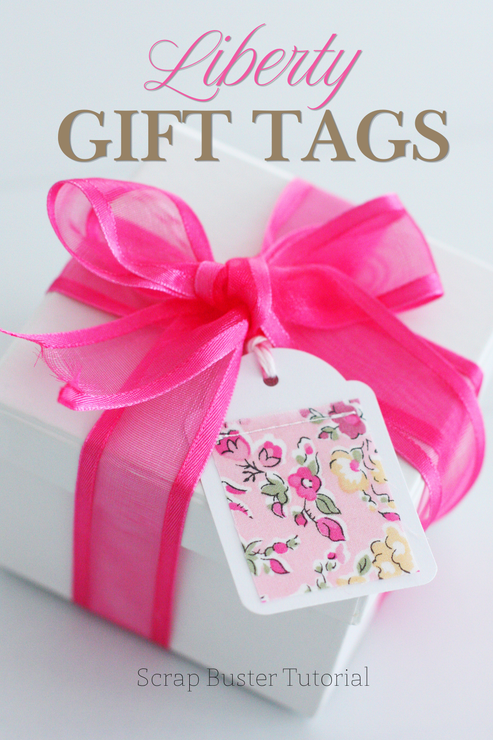 A gift box wrapped in a bright pink ribbon and finished with a Liberty fabric gift tag