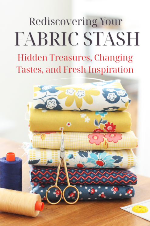 Small stack of fabrics, with cotton reels and scissors in fore ground.