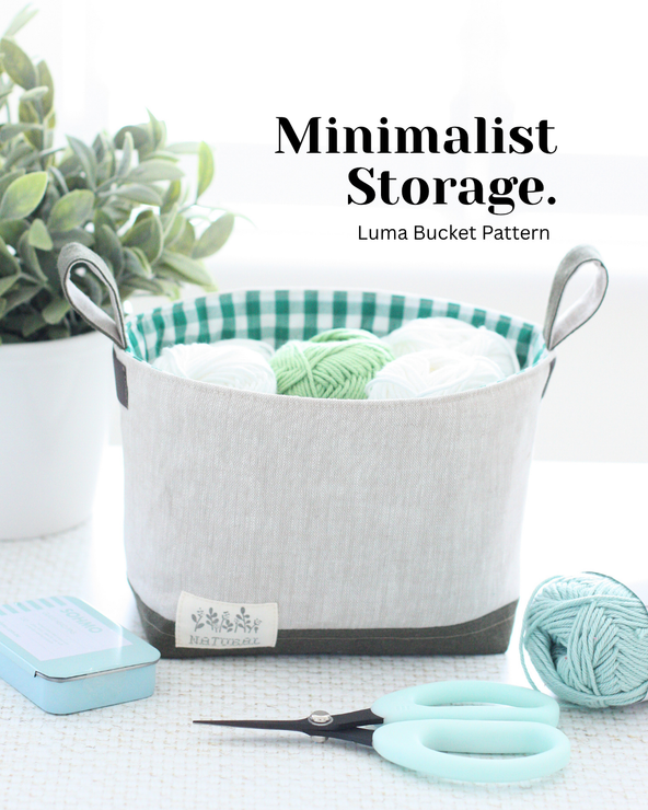 Luma Bucket sewing pattern made in Hasting Street Linen, styled with cream and green yarn for minimalist craft room storage.