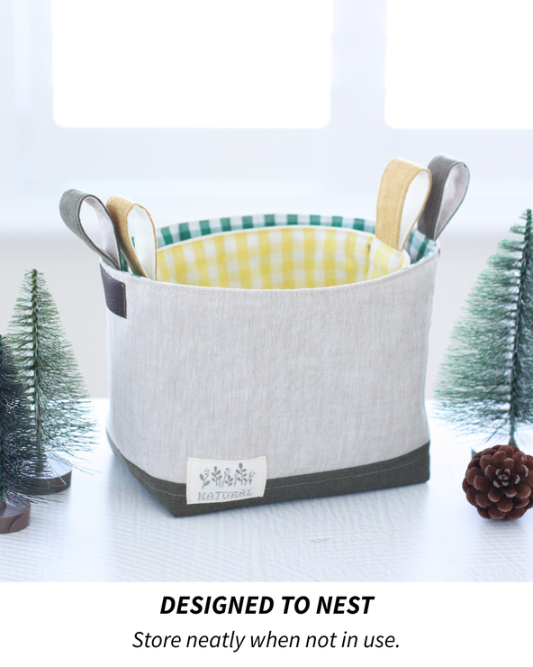 Pair of handmade fabric storage buckets in neutral linen fabrics, sewn using the Luma Bucket pattern.