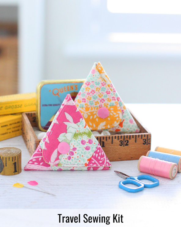 Portable fabric travel sewing kit opened to reveal organized sewing essentials for stitching on the go.