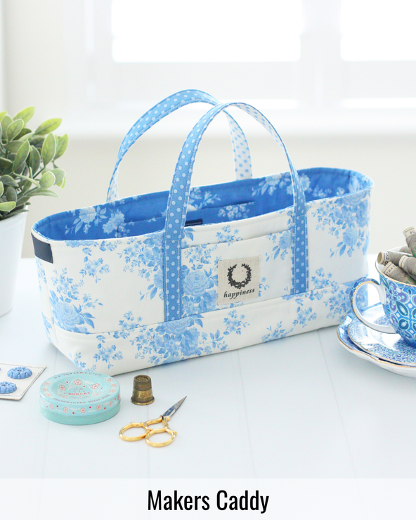 Makers Caddy sewing organizer featuring multiple compartments for storing sewing notions, thread, clips, and tools in a compact fabric basket.