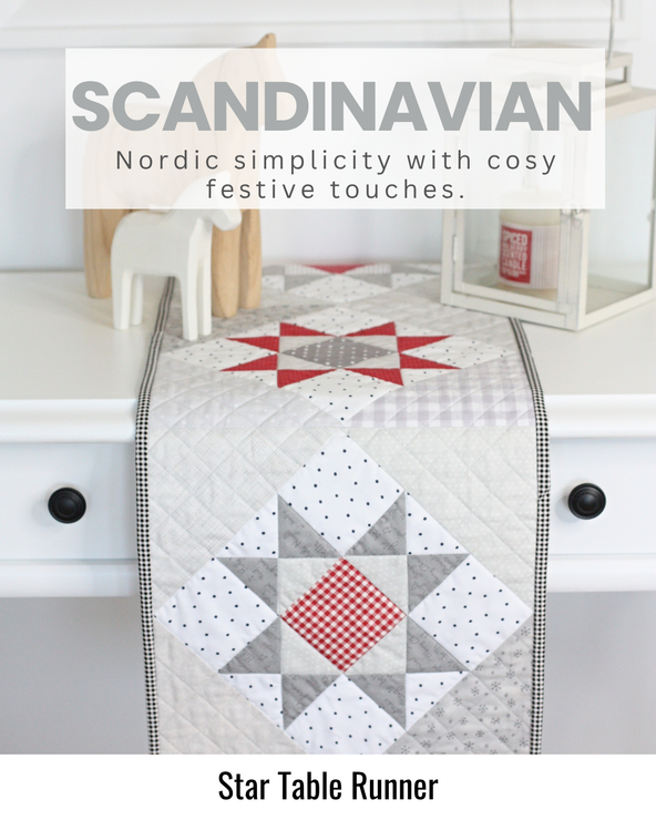 Quilted star table runner in Scandinavian-inspired red, grey and white Christmas fabrics displayed on a festive dining table.