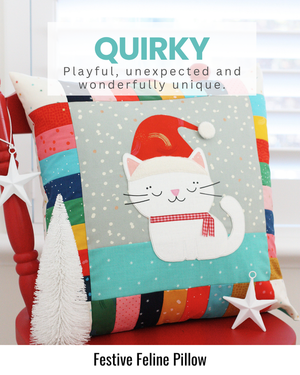 Decorative Christmas pillow featuring a festive cat design made with colourful fabrics and playful holiday details.